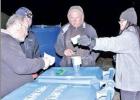 FAR LEFT: A scavenger hunt team studies clues they found in a blue Solo cup on the New Year’s Eve Midnight Hike at Fort Parker State Park. The goal was to guess all 12 Texas wildlife from clues they found hidden at the park.